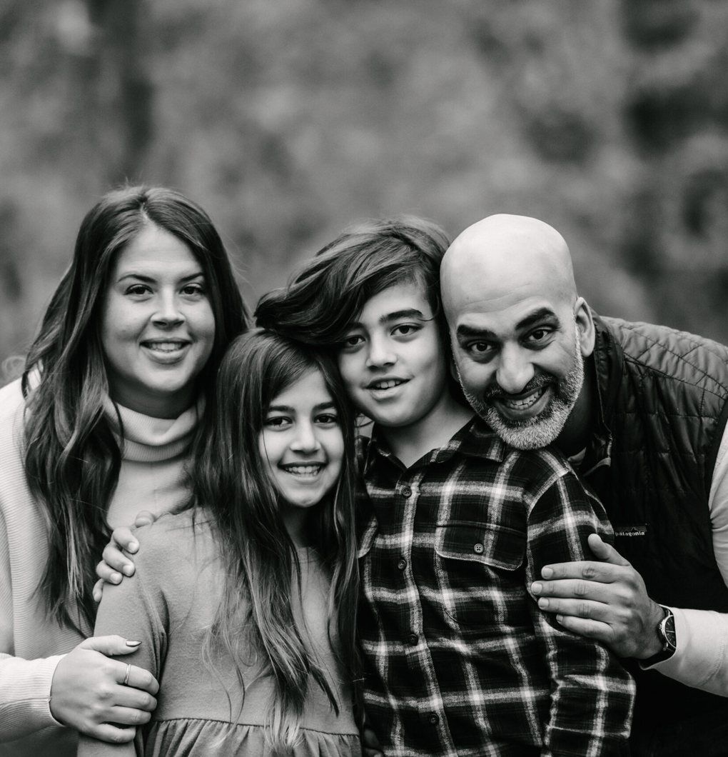 Forefront Advisory Black and white close-up of a smiling family of four outdoors